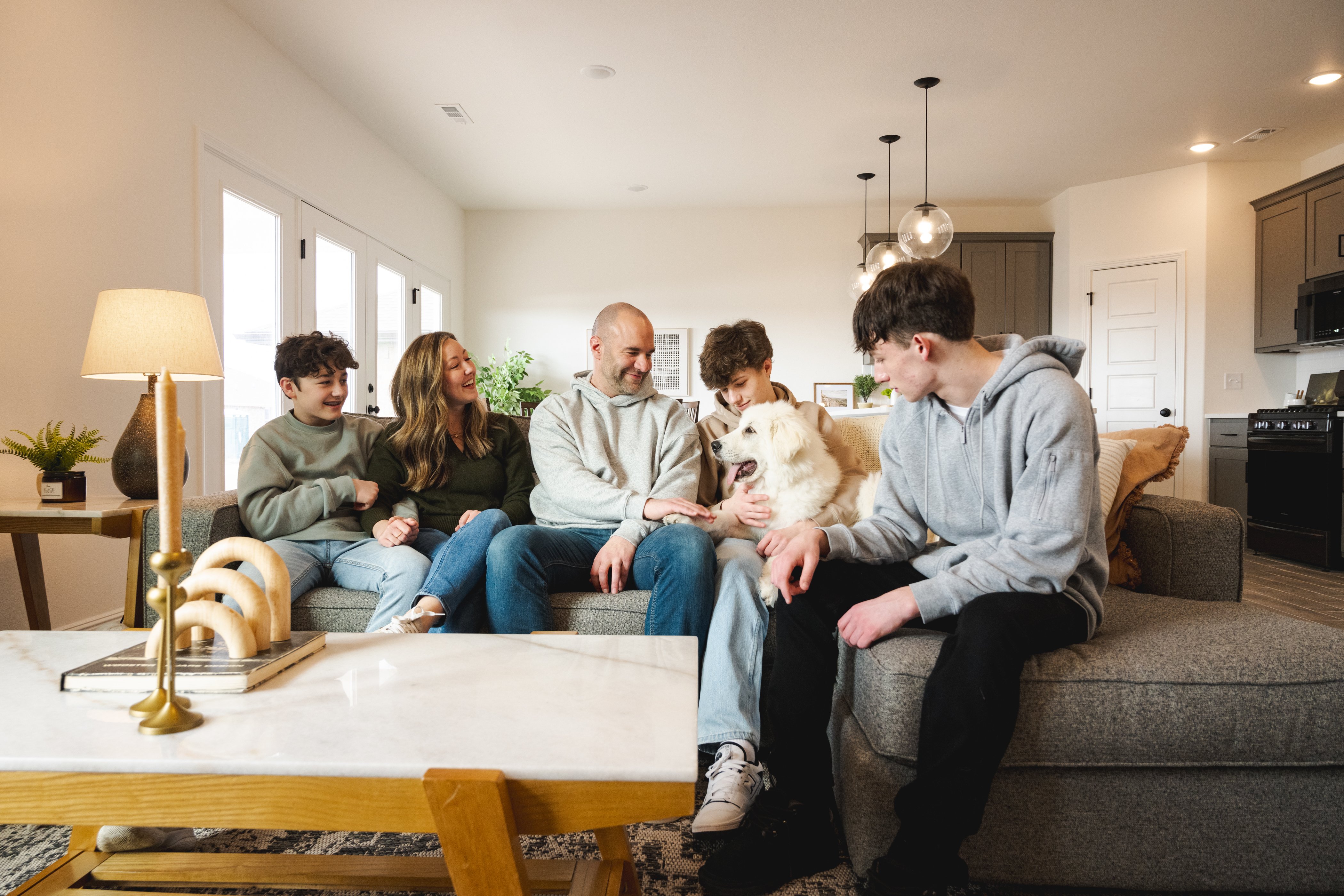 Family on couch enjoying their new home